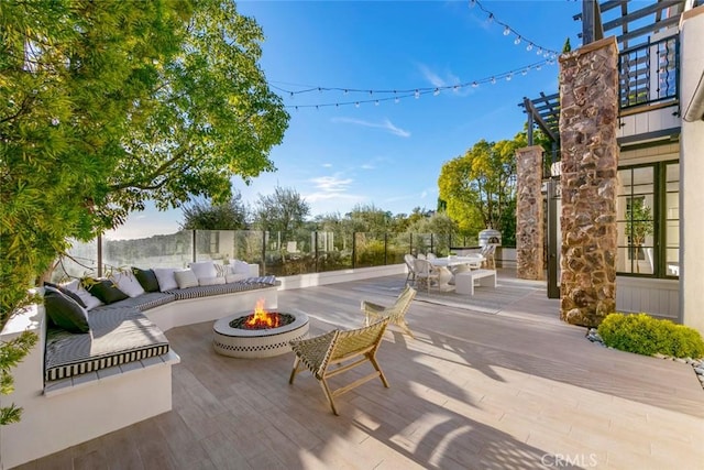 view of patio / terrace featuring an outdoor living space with a fire pit