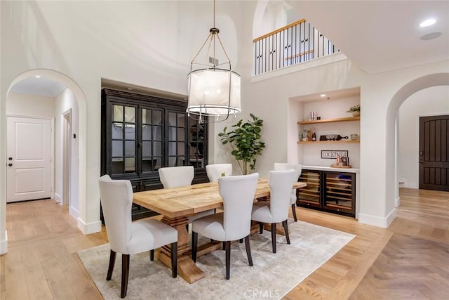 dining space with light hardwood / wood-style flooring and a notable chandelier