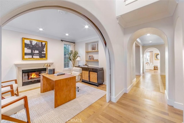 hallway featuring ornamental molding and light hardwood / wood-style floors