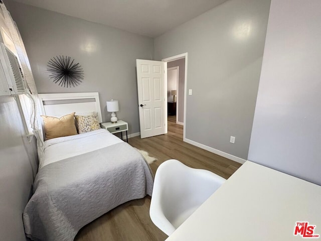 bedroom featuring dark hardwood / wood-style flooring