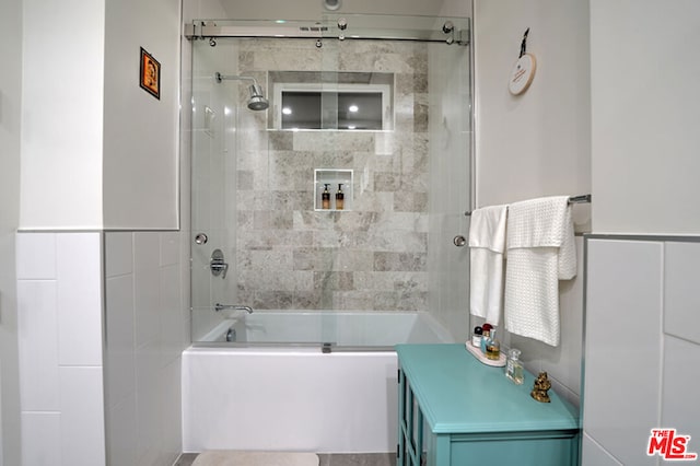 bathroom featuring shower / bath combination with glass door