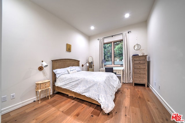 bedroom with light hardwood / wood-style floors