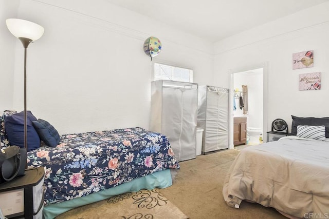 bedroom with carpet floors and ensuite bath