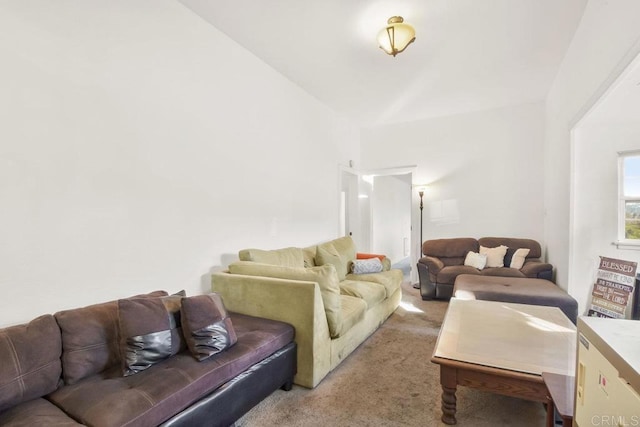 living room featuring light carpet and vaulted ceiling