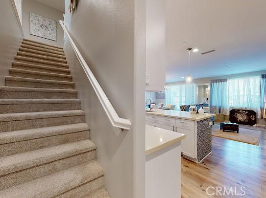 stairway featuring hardwood / wood-style flooring