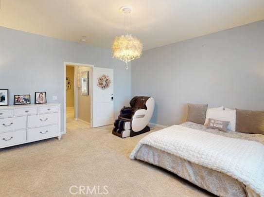 carpeted bedroom featuring a chandelier