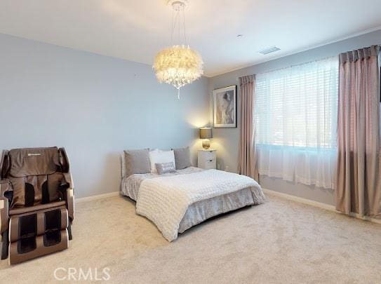 bedroom featuring a notable chandelier and carpet flooring