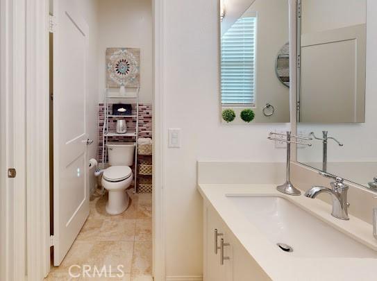 bathroom featuring toilet and vanity