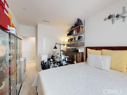 bedroom with light colored carpet