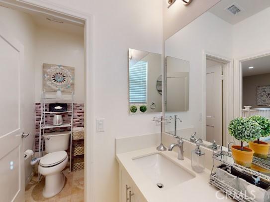 bathroom with toilet and vanity