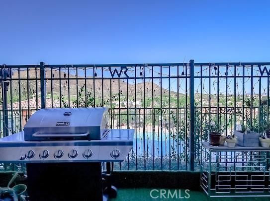 exterior space featuring a community pool and a grill