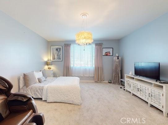 bedroom featuring an inviting chandelier and carpet floors