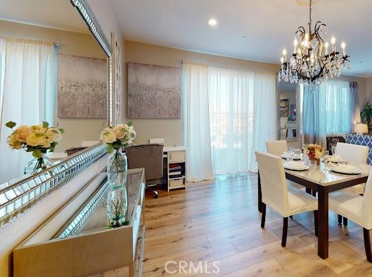 dining room with a chandelier and light hardwood / wood-style flooring