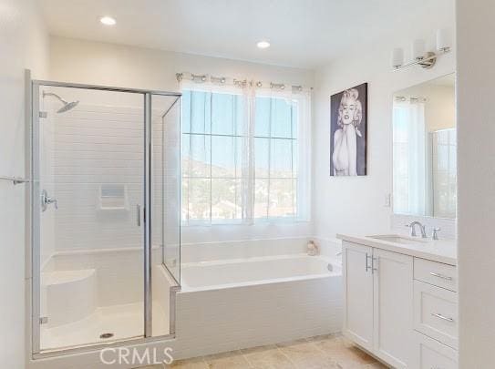 bathroom with vanity, tile patterned flooring, and plus walk in shower