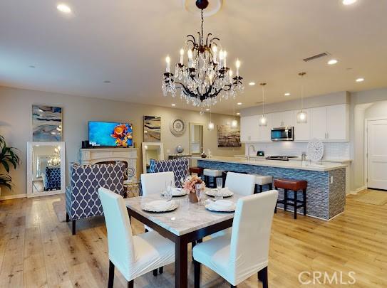 dining space featuring a chandelier and light hardwood / wood-style flooring