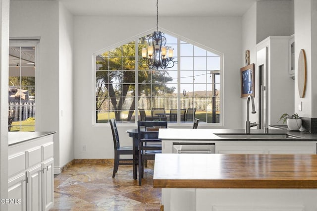 dining space with sink, a chandelier, and a wealth of natural light