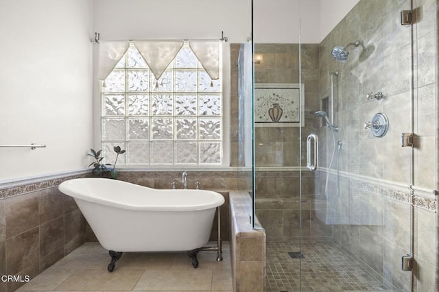 bathroom featuring plus walk in shower, tile patterned flooring, and tile walls