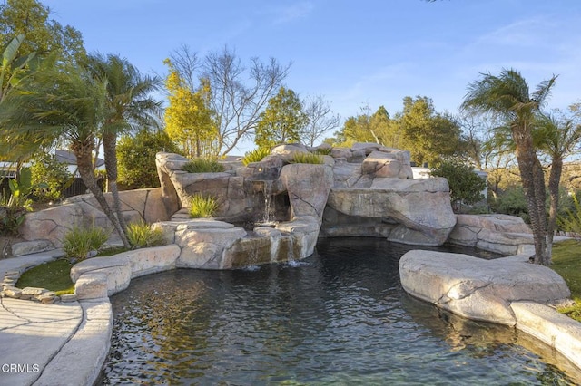 exterior space with a garden pond