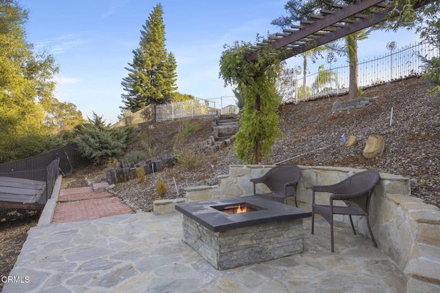 view of patio / terrace with a fire pit and a pergola