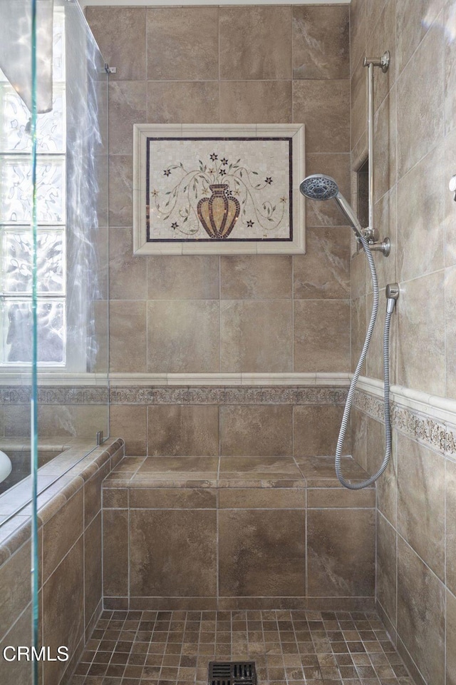 bathroom with tiled shower