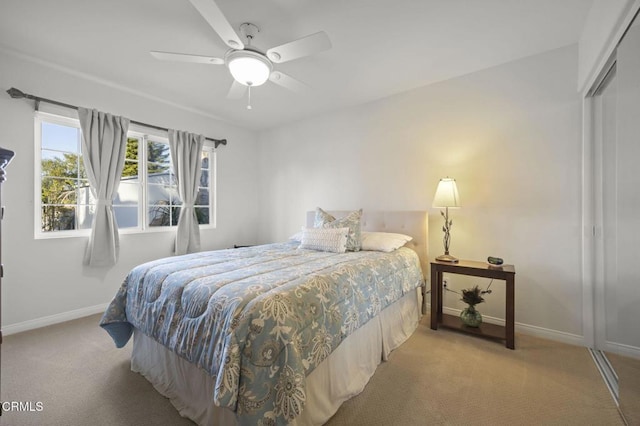 carpeted bedroom featuring a closet and ceiling fan