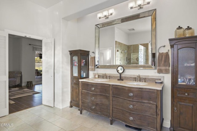 bathroom with walk in shower, tile patterned floors, and vanity