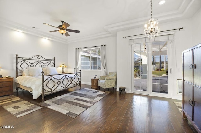 bedroom featuring ceiling fan with notable chandelier, a tray ceiling, dark hardwood / wood-style flooring, and access to outside