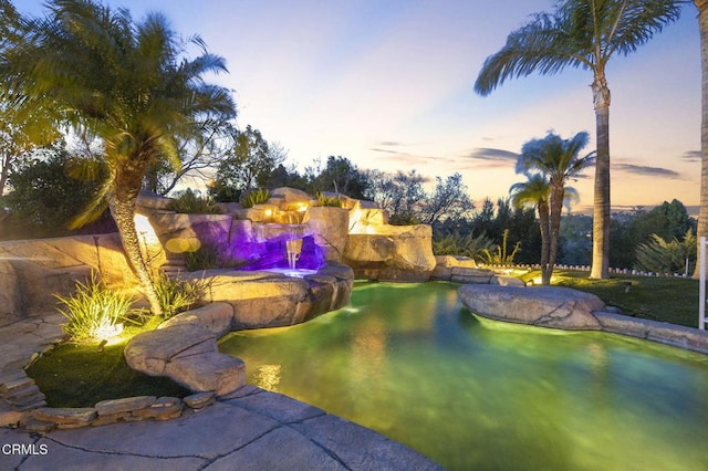 view of pool at dusk