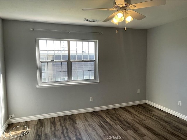 empty room featuring ceiling fan and dark wood-type flooring