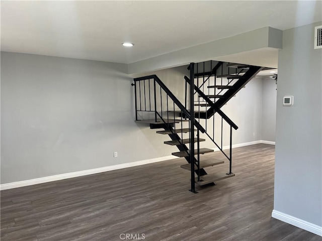 staircase with hardwood / wood-style flooring