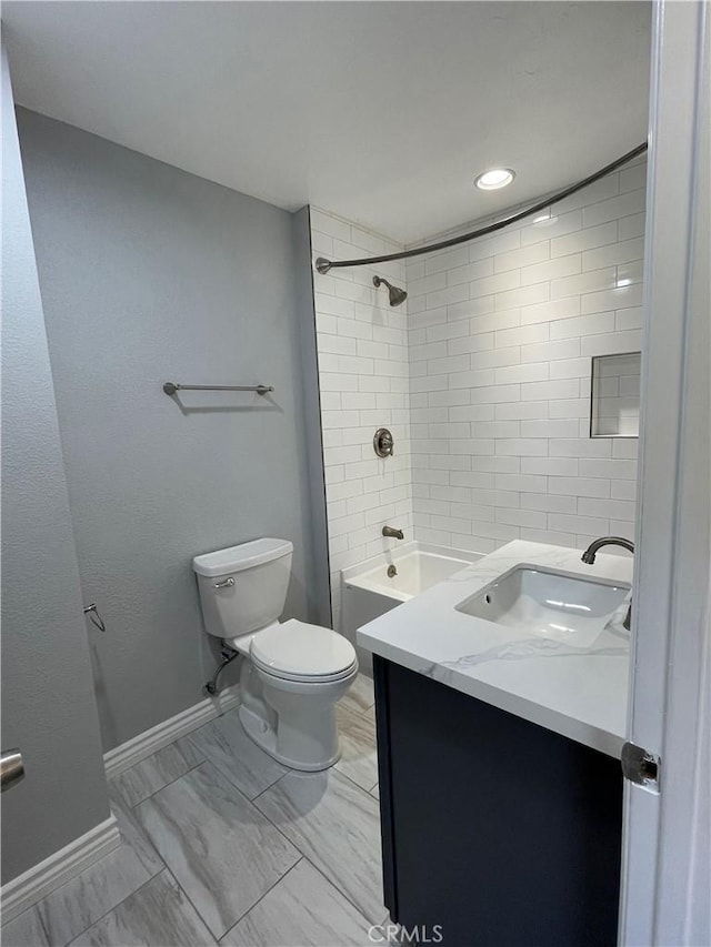 full bathroom with toilet, tiled shower / bath combo, and vanity