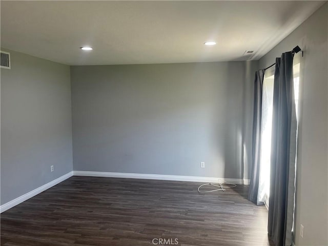 empty room with dark wood-type flooring