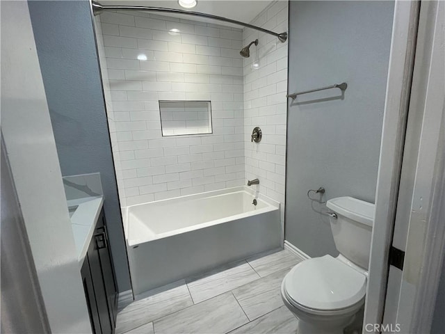 full bathroom with toilet, tiled shower / bath, and vanity