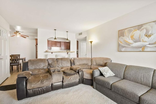 living room with ceiling fan and light tile patterned floors