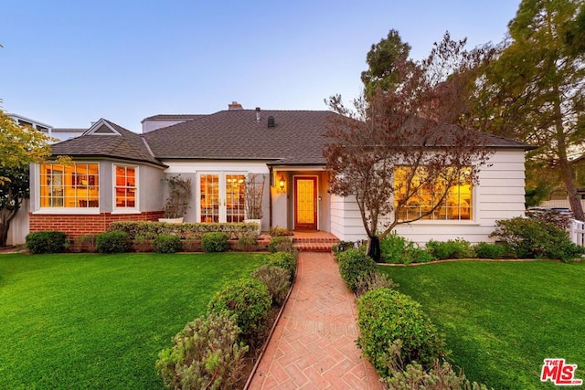 ranch-style home featuring a front yard