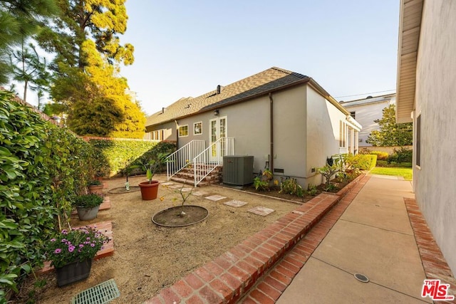 back of house with a patio area and cooling unit