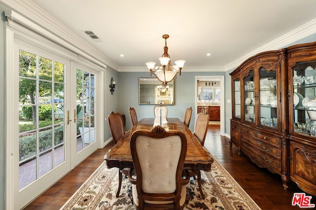 dining area with french doors, dark hardwood / wood-style floors, crown molding, and a chandelier