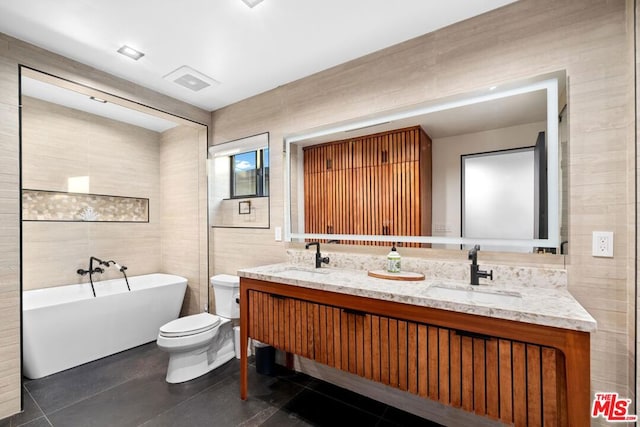 bathroom with toilet, tile walls, tile patterned floors, and a tub