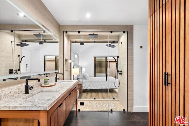 bathroom featuring walk in shower and vanity