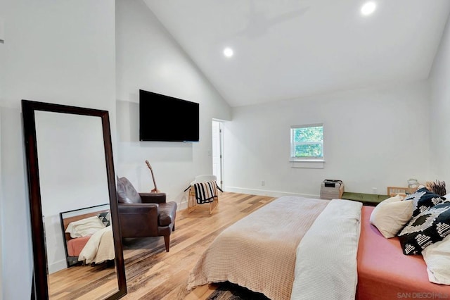 bedroom featuring high vaulted ceiling and light wood-type flooring