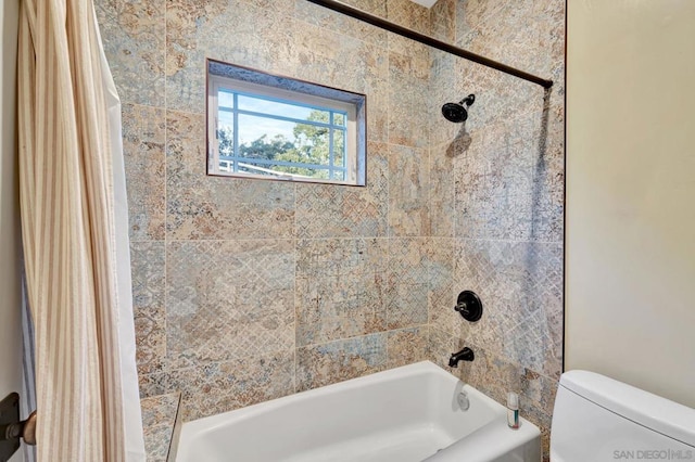 bathroom with toilet and shower / bath combination with curtain