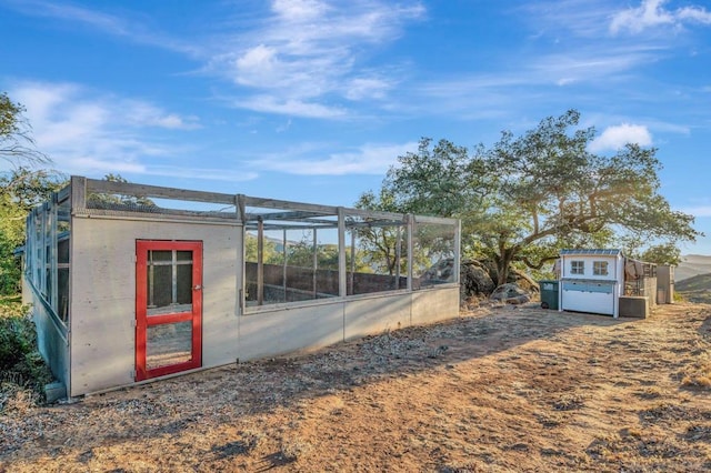 view of side of property featuring an outbuilding