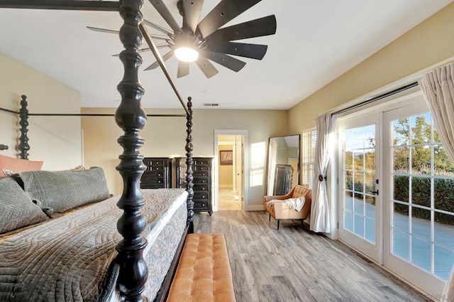 bedroom with ceiling fan, ensuite bath, light hardwood / wood-style flooring, and access to outside