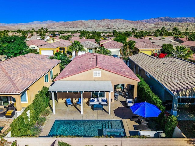 birds eye view of property with a mountain view