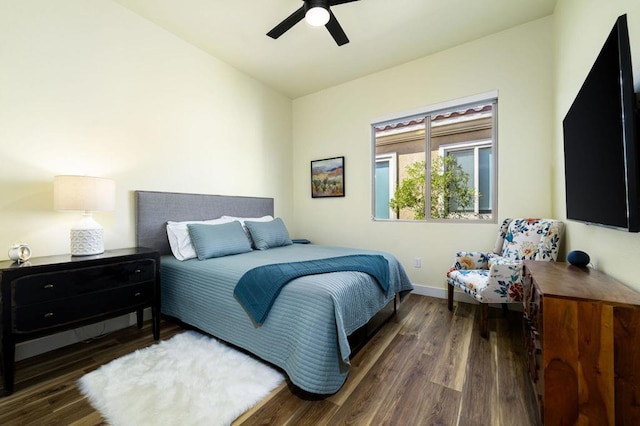 bedroom featuring ceiling fan, dark hardwood / wood-style floors, and lofted ceiling