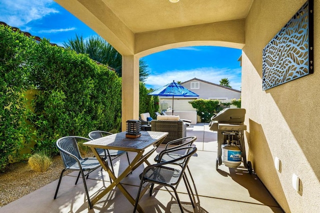 view of patio with an outdoor hangout area and grilling area