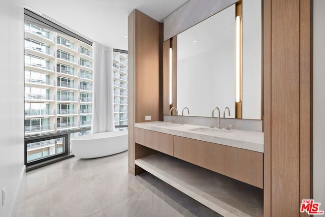 bathroom with a wall of windows, a bathtub, and vanity