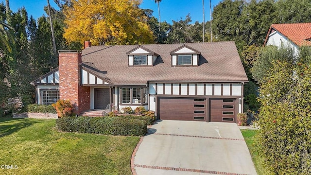 view of front facade with a front yard and a garage