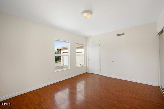 unfurnished room with hardwood / wood-style floors