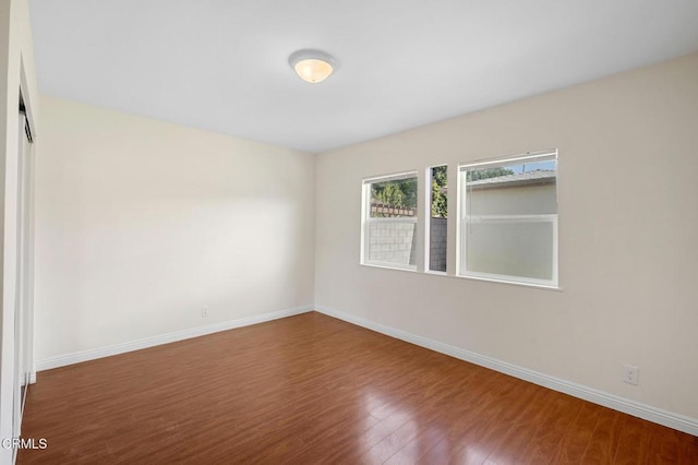 spare room with hardwood / wood-style floors